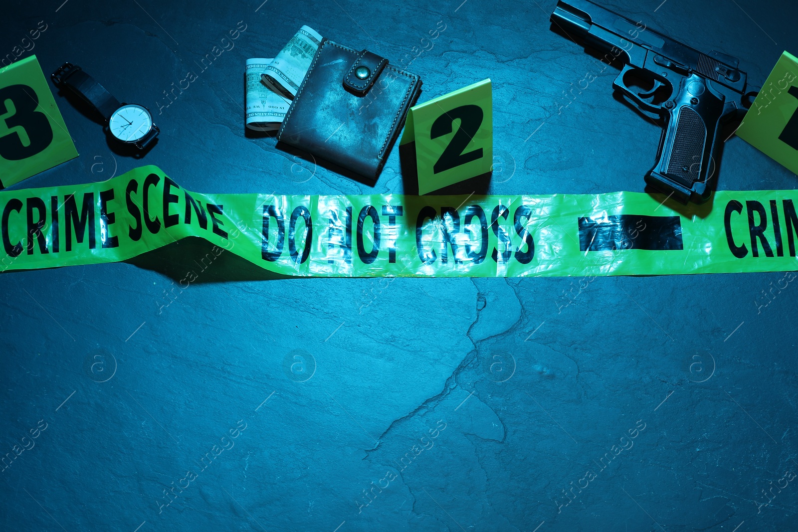 Forensic expertise. Crime scene with evidence, markers, police tape on blue background, flat lay and space for text. Color toned effect Photo of Forensic expertise. Crime scene with evidence, markers, police tape on blue background, flat lay and space for text. Color toned effect