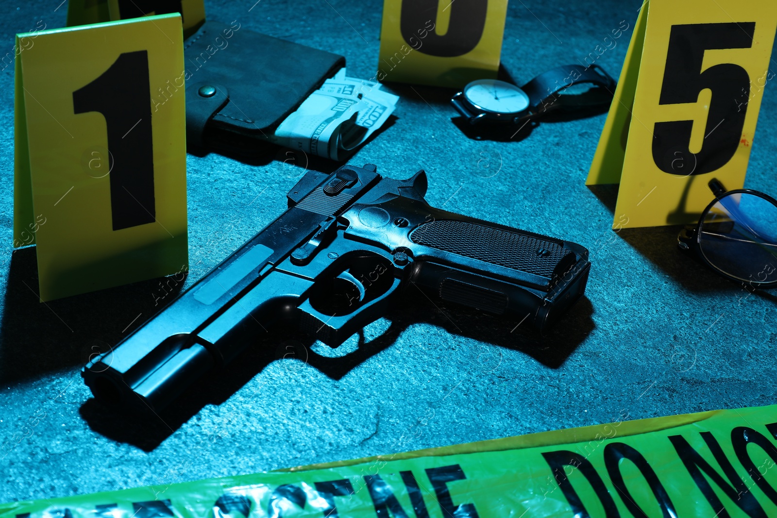 Forensic expertise. Crime scene with evidence, markers and police tape on blue background, closeup. Color toned effect Photo of Forensic expertise. Crime scene with evidence, markers and police tape on blue background, closeup. Color toned effect