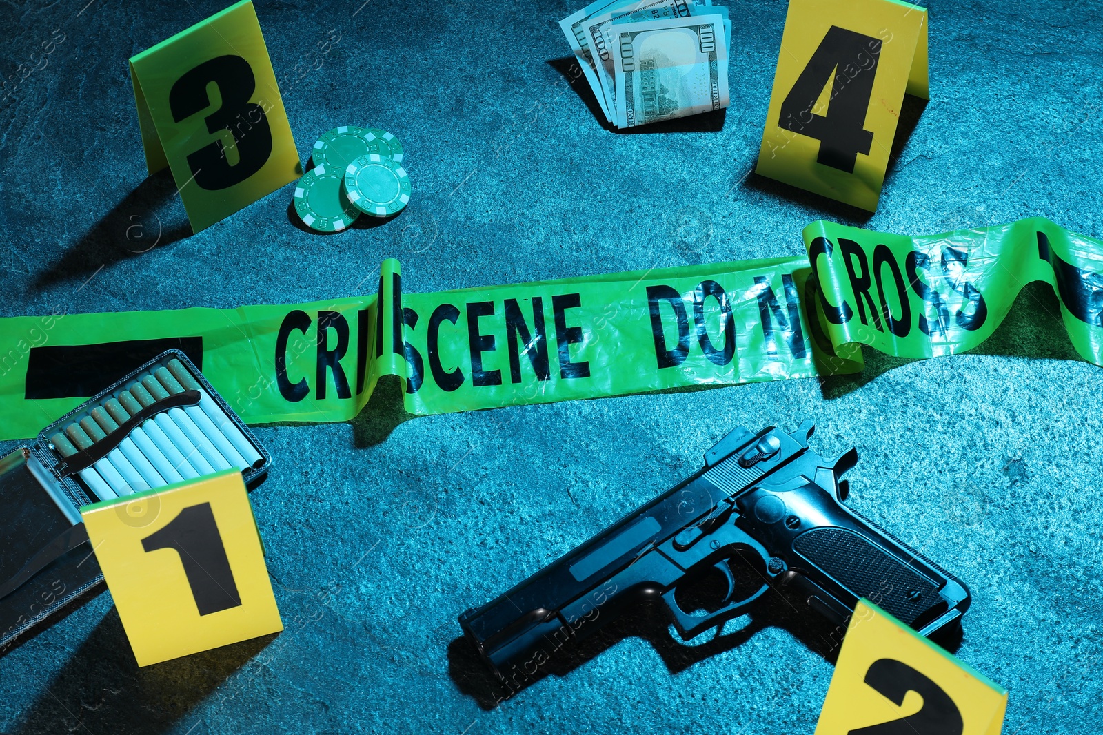 Forensic expertise. Crime scene with evidence, markers and police tape on blue background, closeup. Color toned effect Photo of Forensic expertise. Crime scene with evidence, markers and police tape on blue background, closeup. Color toned effect