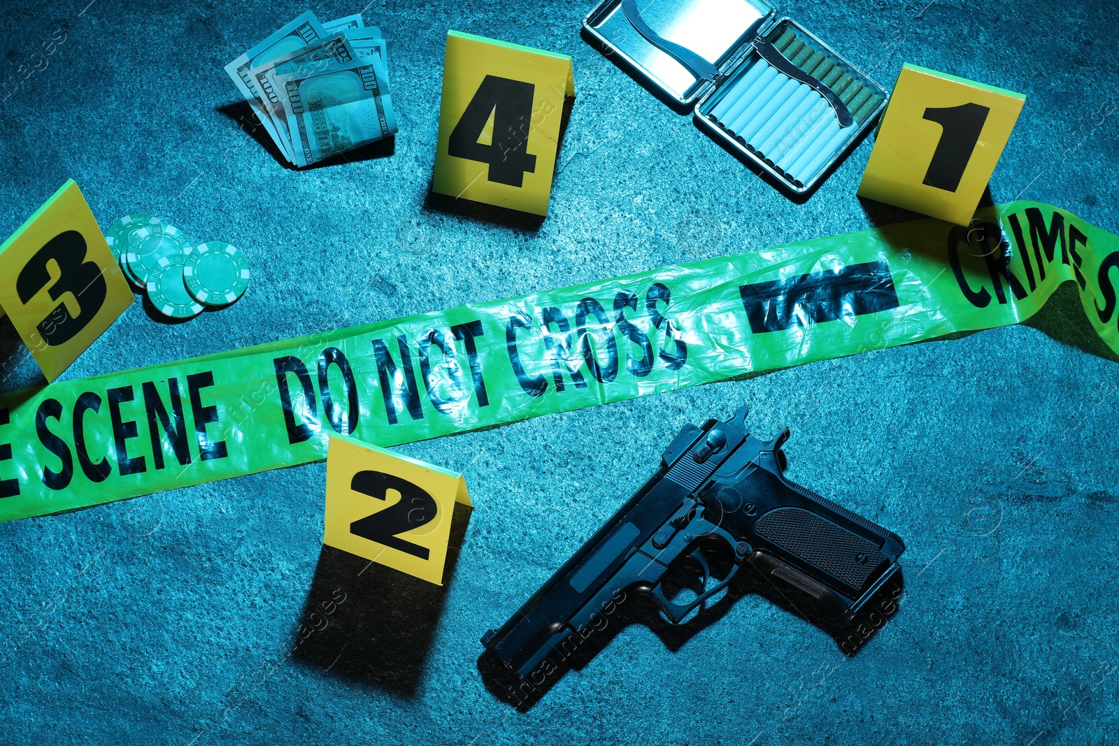 Forensic expertise. Crime scene with evidence, markers and police tape on blue background, flat lay. Color toned effect Photo of Forensic expertise. Crime scene with evidence, markers and police tape on blue background, flat lay. Color toned effect