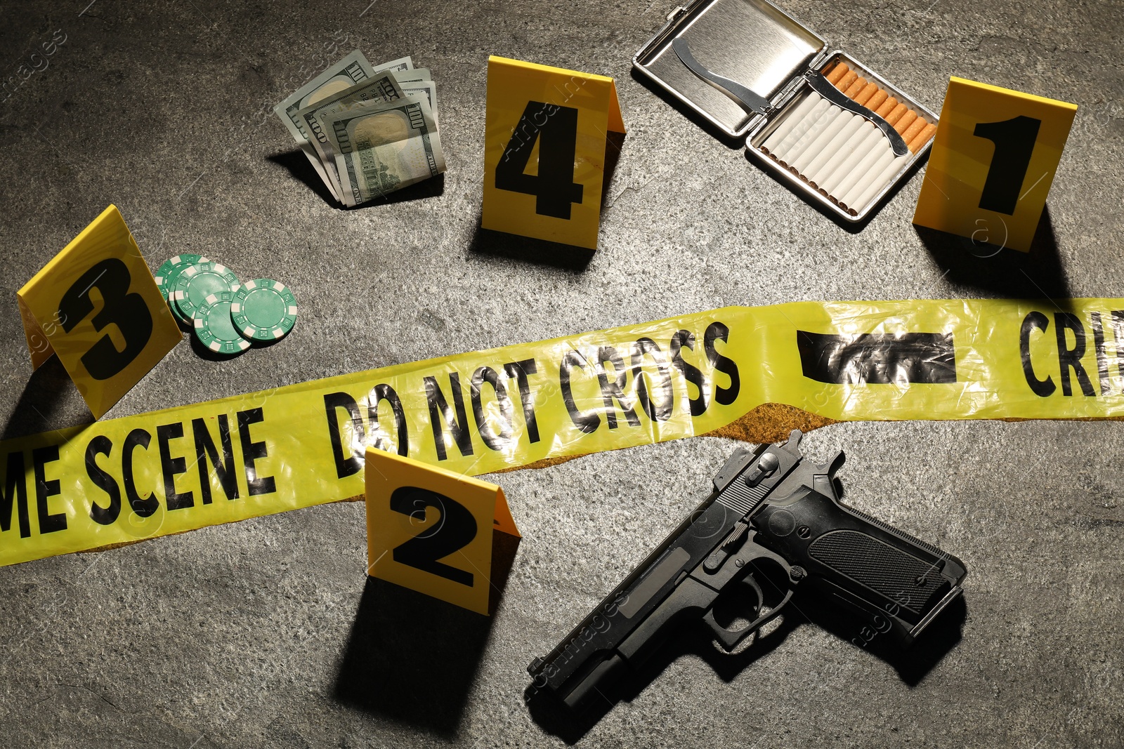 Forensic expertise. Crime scene with evidence, markers and police tape on grey background Photo of Forensic expertise. Crime scene with evidence, markers and police tape on grey background