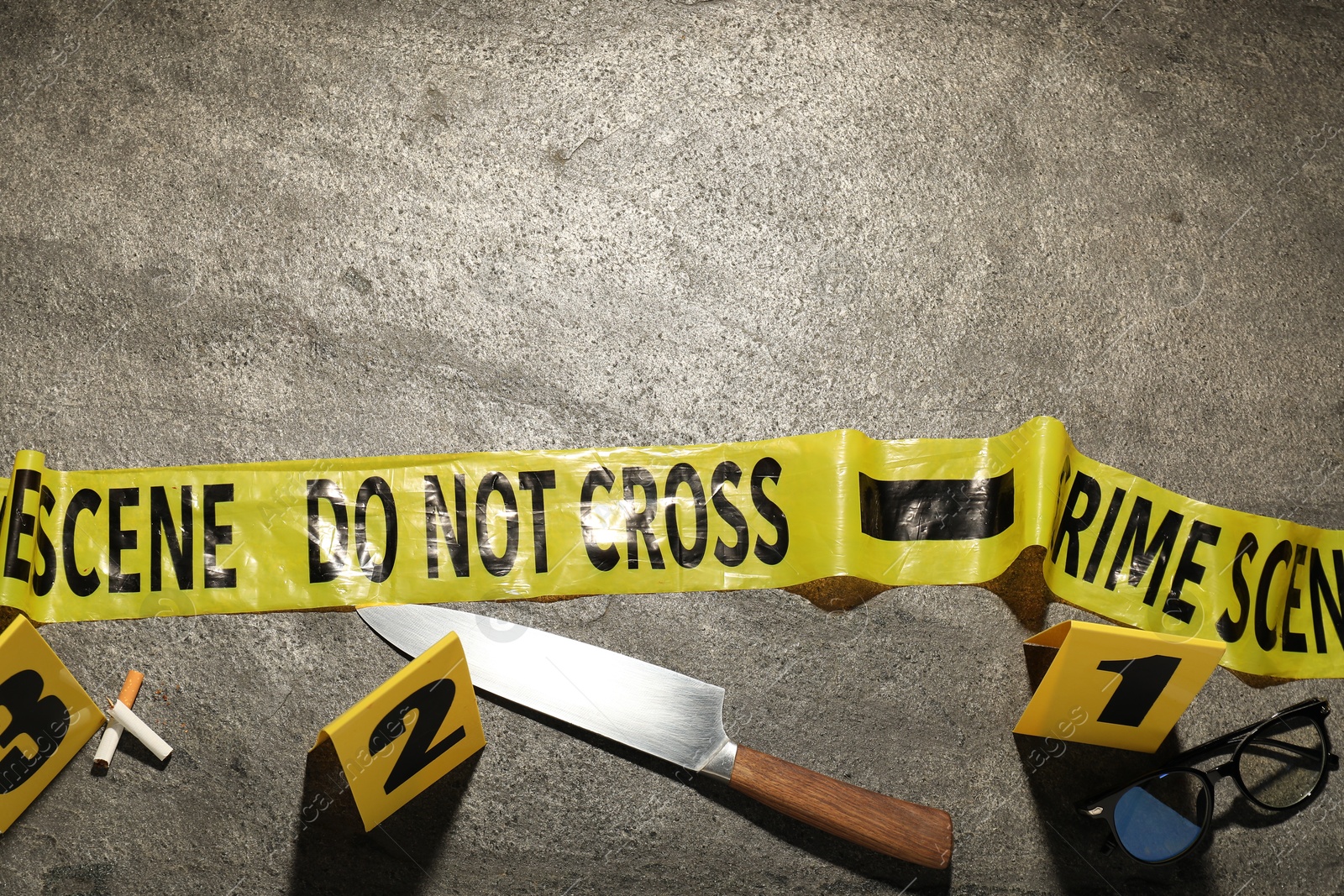 Forensic expertise. Crime scene with evidence, markers and police tape on grey background, flat lay. Space for text Photo of Forensic expertise. Crime scene with evidence, markers and police tape on grey background, flat lay. Space for text
