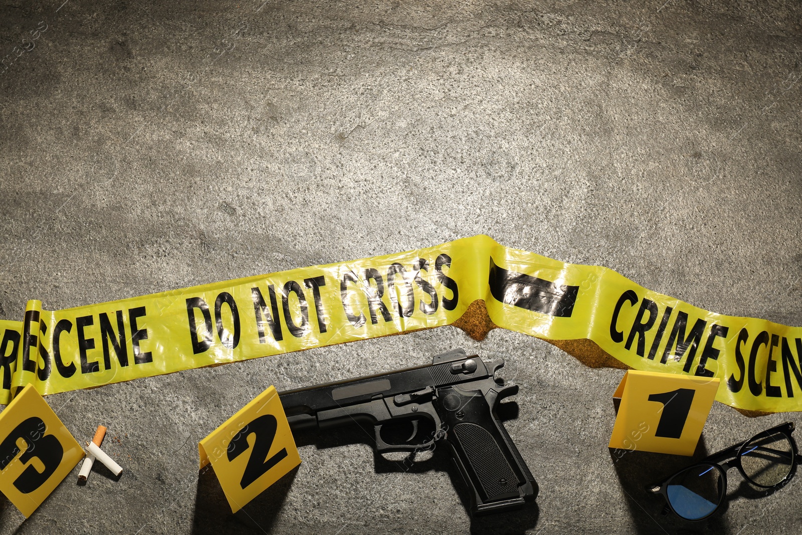 Forensic expertise. Crime scene with evidence, markers and police tape on grey background, flat lay. Space for text Photo of Forensic expertise. Crime scene with evidence, markers and police tape on grey background, flat lay. Space for text