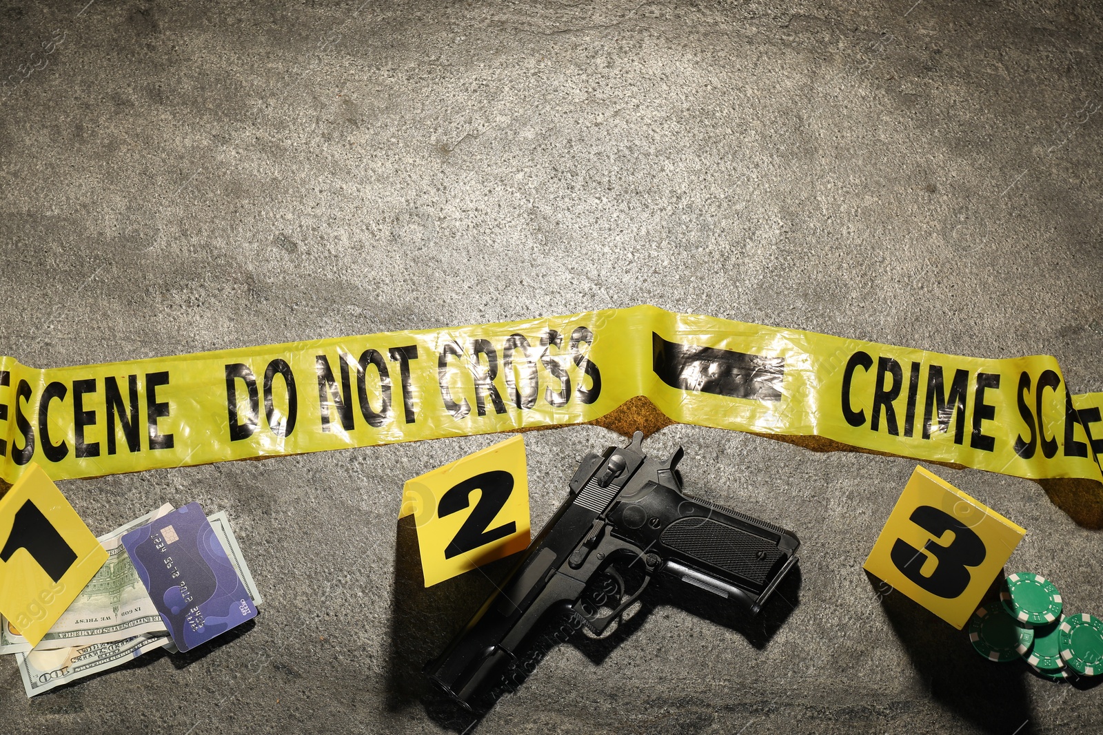 Forensic expertise. Crime scene with evidence, markers and police tape on grey background, flat lay. Space for text Photo of Forensic expertise. Crime scene with evidence, markers and police tape on grey background, flat lay. Space for text