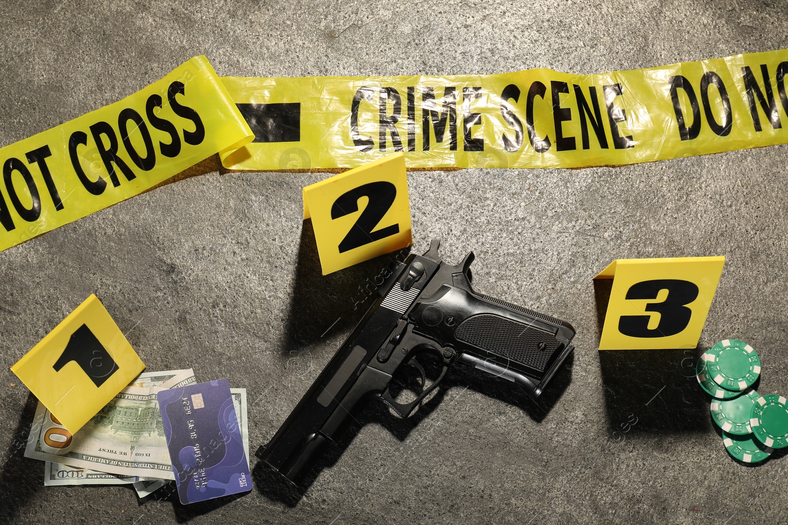 Forensic expertise. Crime scene with evidence, markers and police tape on grey background, flat lay Photo of Forensic expertise. Crime scene with evidence, markers and police tape on grey background, flat lay