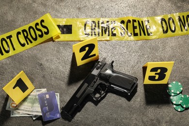 Photo of Forensic expertise. Crime scene with evidence, markers and police tape on grey background, flat lay