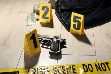 Photo of Forensic expertise. Crime scene with evidence, markers and police tape on floor, closeup