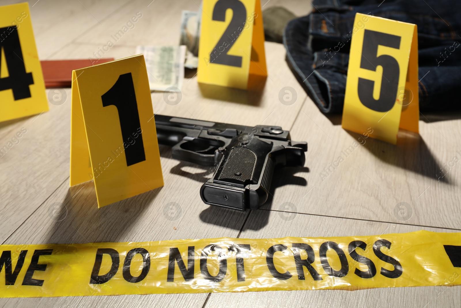 Forensic expertise. Crime scene with evidence, markers and police tape on floor, closeup Photo of Forensic expertise. Crime scene with evidence, markers and police tape on floor, closeup