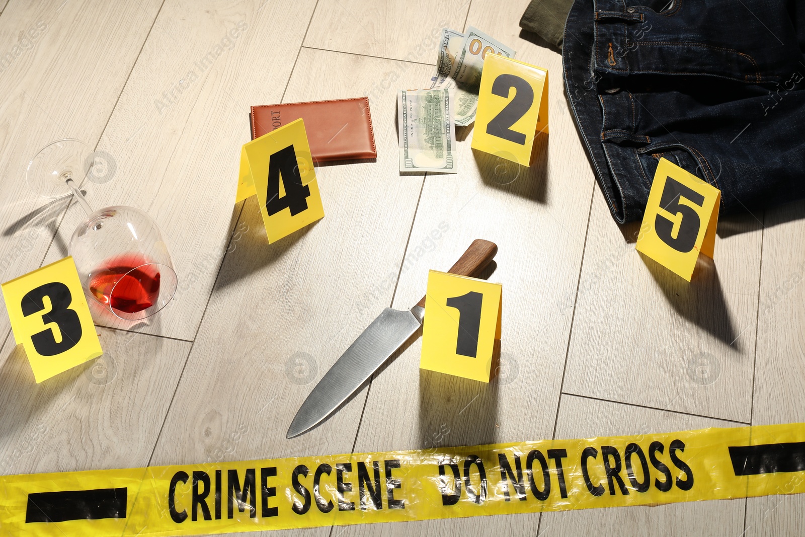 Forensic expertise. Crime scene with evidence, markers and police tape on floor Photo of Forensic expertise. Crime scene with evidence, markers and police tape on floor