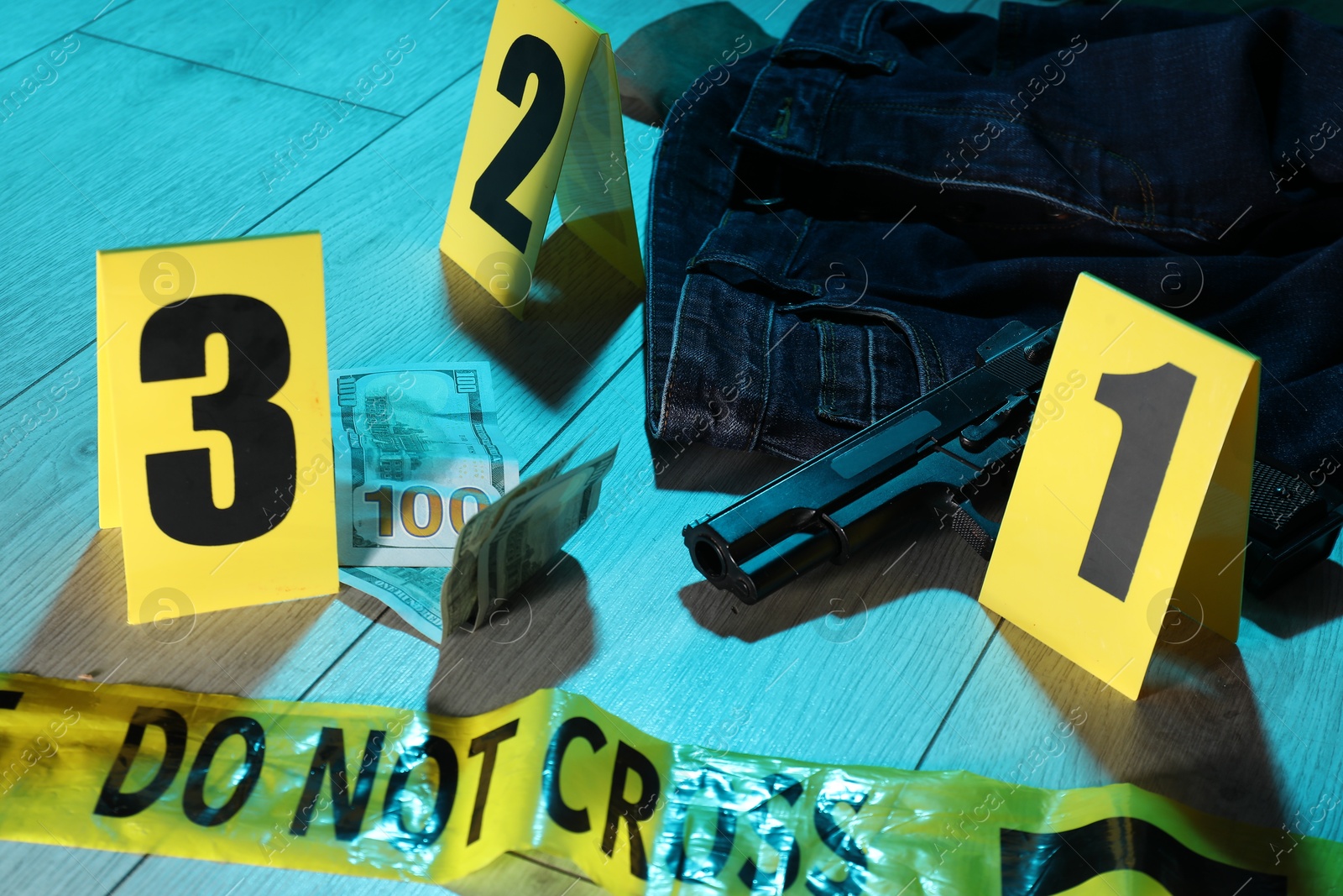 Photo of Forensic expertise. Crime scene with evidence, markers and police tape on floor, closeup. Color toned effect