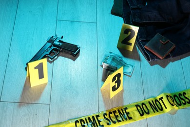 Photo of Forensic expertise. Crime scene with evidence, markers and police tape on floor. Color toned effect
