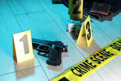 Photo of Forensic expertise. Crime scene with evidence, markers and police tape on floor, closeup. Color toned effect