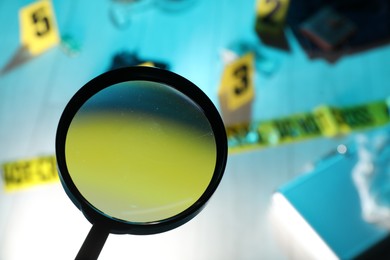 Photo of Forensic expertise. Magnifying glass against crime scene, selective focus