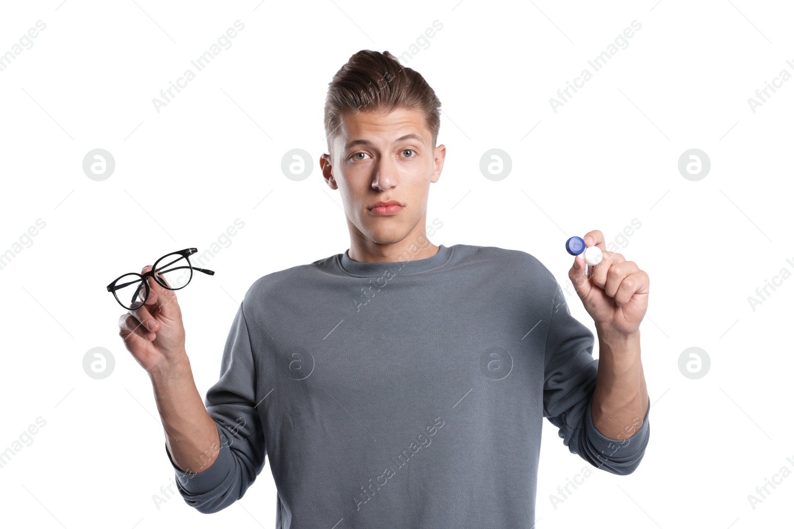 Man choosing between glasses and contact lenses on white background Photo of Man choosing between glasses and contact lenses on white background