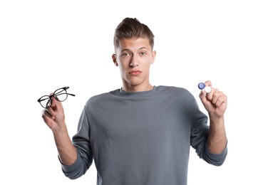 Photo of Man choosing between glasses and contact lenses on white background
