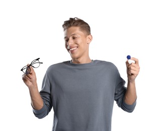 Photo of Man choosing between glasses and contact lenses on white background