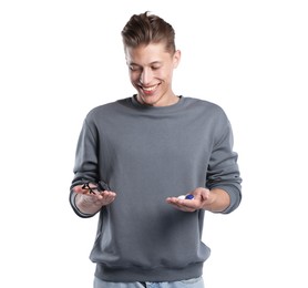 Photo of Man choosing between glasses and contact lenses on white background