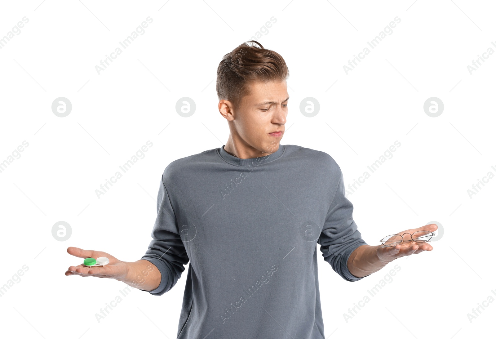Man choosing between glasses and contact lenses on white background Photo of Man choosing between glasses and contact lenses on white background