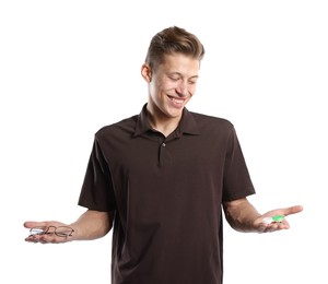 Photo of Man choosing between glasses and contact lenses on white background