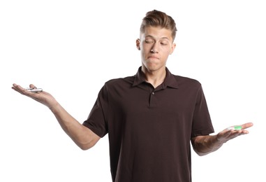 Photo of Man choosing between glasses and contact lenses on white background