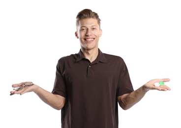 Photo of Man choosing between glasses and contact lenses on white background