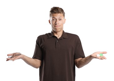 Photo of Man choosing between glasses and contact lenses on white background