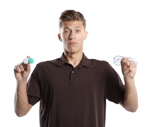 Photo of Man choosing between glasses and contact lenses on white background