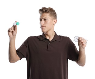 Photo of Man choosing between glasses and contact lenses on white background