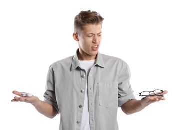 Photo of Man choosing between glasses and contact lenses on white background