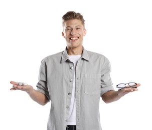 Photo of Man choosing between glasses and contact lenses on white background