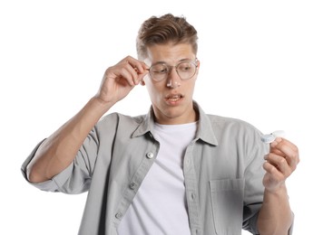 Photo of Man choosing between glasses and contact lenses on white background