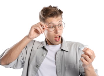 Photo of Man choosing between glasses and contact lenses on white background