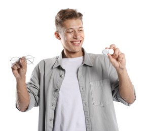Photo of Man choosing between glasses and contact lenses on white background