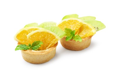 Photo of Tartlets with fruits and mint isolated on white. Delicious dessert