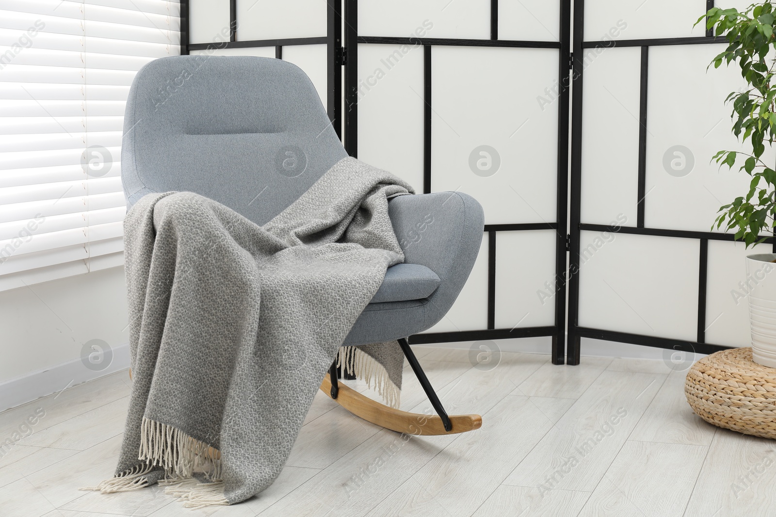 Comfortable armchair with gray woolen blanket indoors Photo of Comfortable armchair with gray woolen blanket indoors