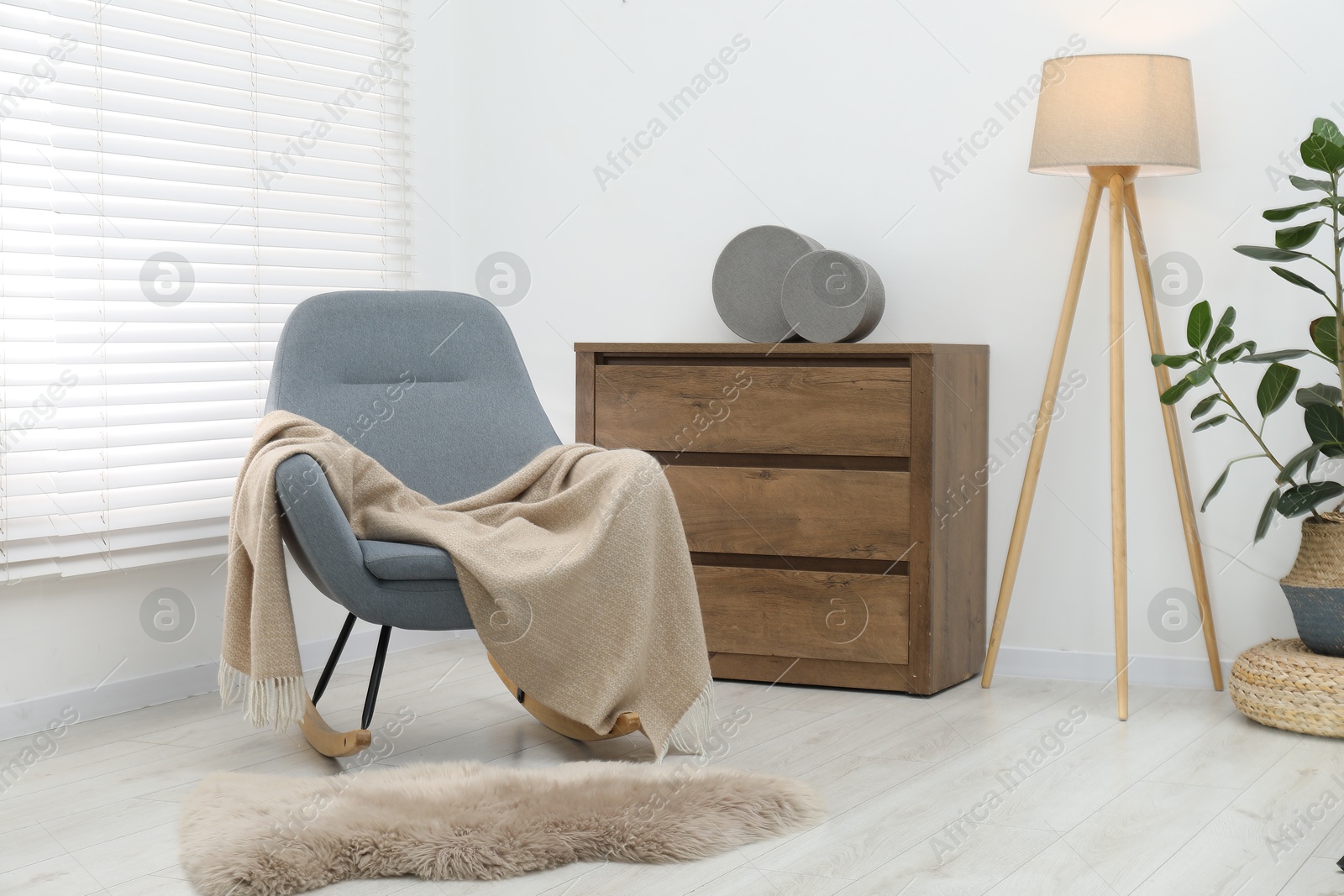 Comfortable armchair with beige woolen blanket indoors Photo of Comfortable armchair with beige woolen blanket indoors