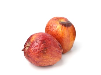 Photo of Two whole rotten apples isolated on white