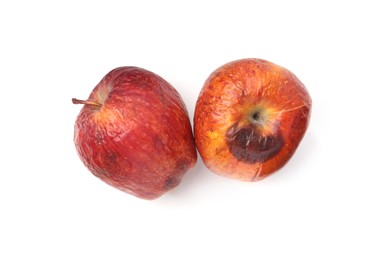 Photo of Rotten apples isolated on white, top view