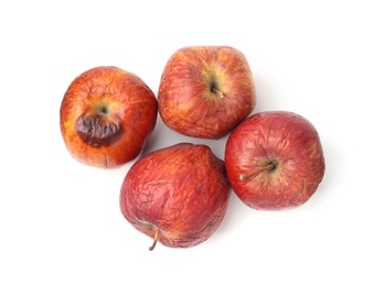 Photo of Rotten apples isolated on white, top view