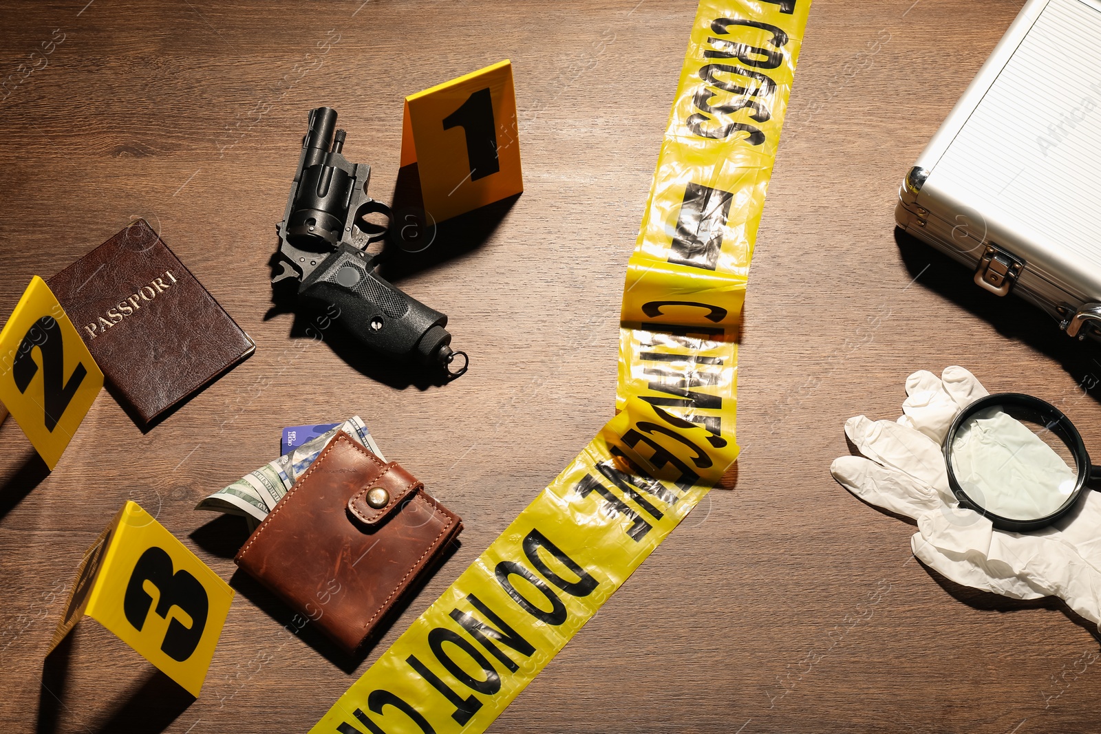 Forensic expertise. Crime scene with evidence, markers and police tape on wooden background Photo of Forensic expertise. Crime scene with evidence, markers and police tape on wooden background