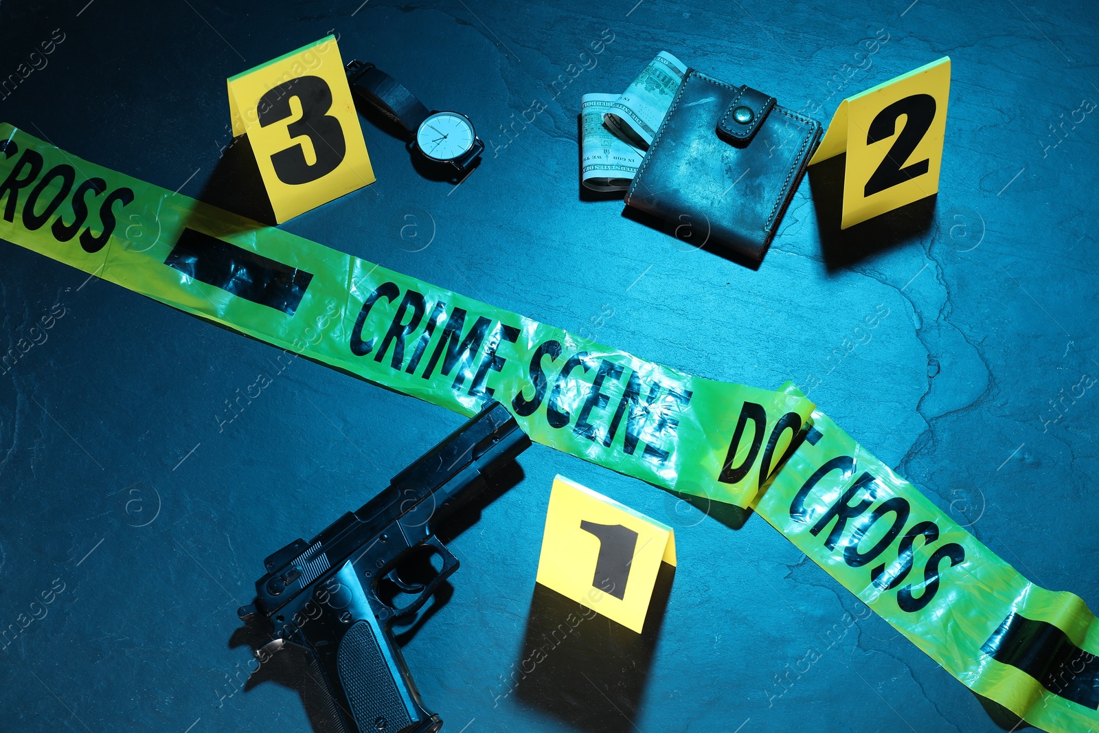 Forensic expertise. Crime scene with evidence, markers and police tape on blue background, flat lay. Color toned effect Photo of Forensic expertise. Crime scene with evidence, markers and police tape on blue background, flat lay. Color toned effect