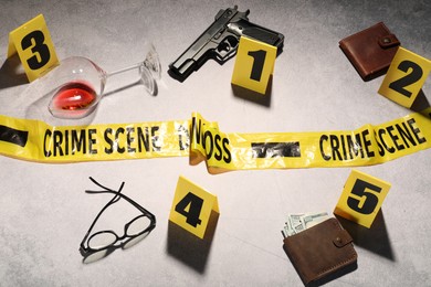 Photo of Forensic expertise. Crime scene with evidence, markers and police tape on light grey background, flat lay
