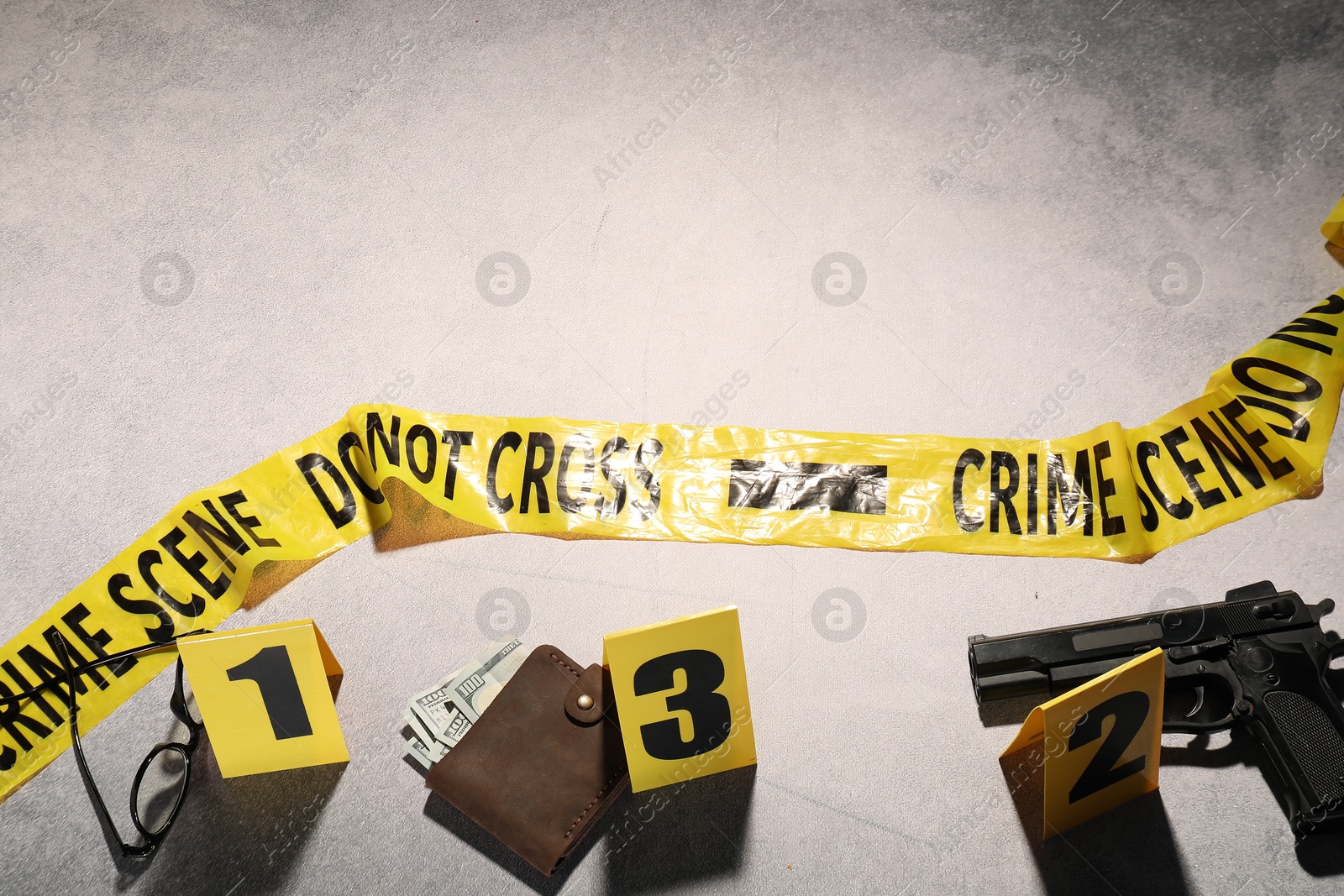 Photo of Forensic expertise. Crime scene with evidence, markers and police tape on light grey background, flat lay. Space for text