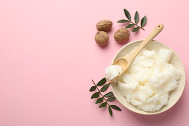 Photo of Natural shea butter, nuts and leaves on pink background, flat lay. Space for text