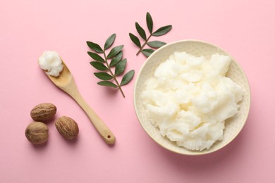 Photo of Natural shea butter, nuts and leaves on pink background, flat lay