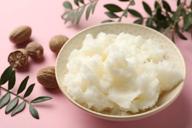 Photo of Natural shea butter on pink background, closeup