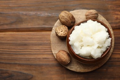 Photo of Natural shea butter on wooden table, top view. Space for text