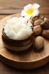 Photo of Natural shea butter on wooden table, closeup