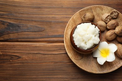 Photo of Natural shea butter on wooden table, top view. Space for text
