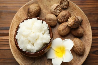 Photo of Natural shea butter on wooden table, top view